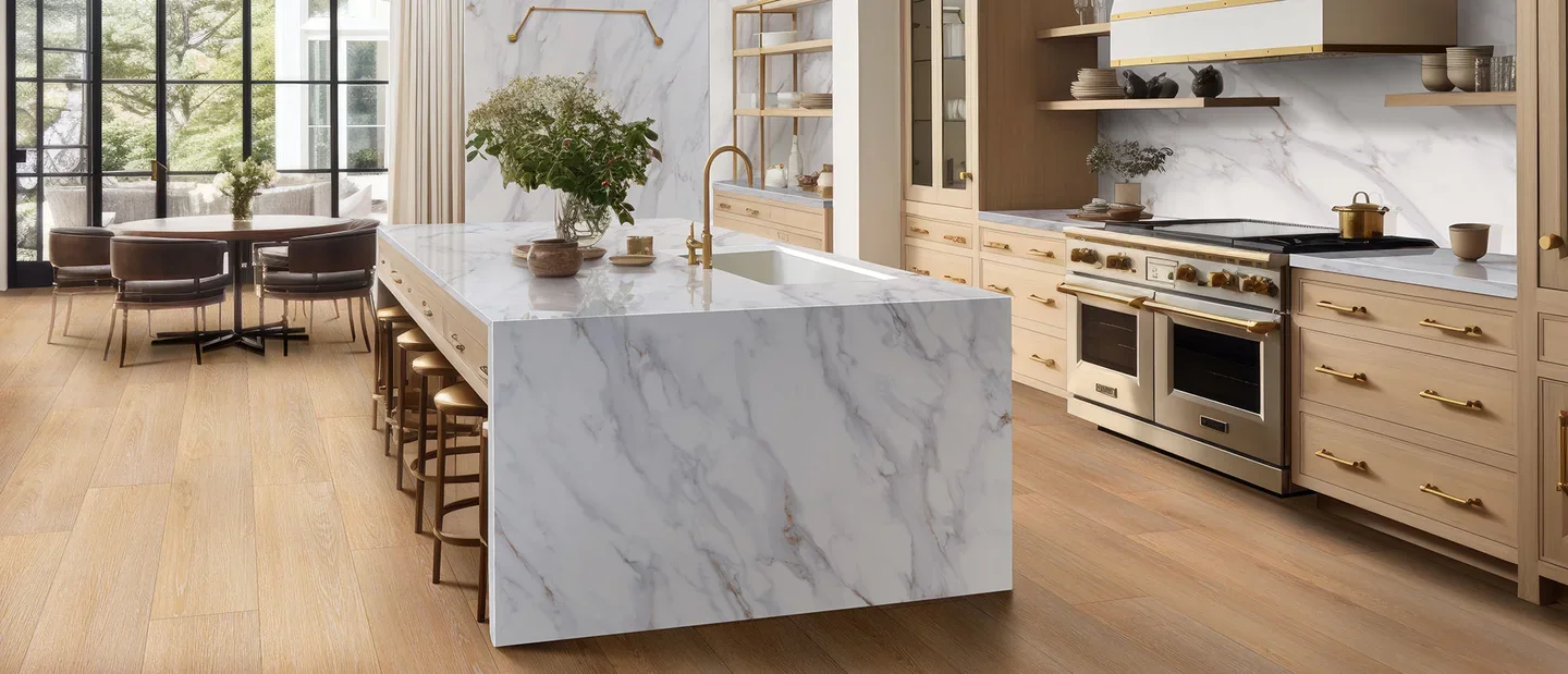 Calacatta Castana quartz on a waterfall island and backsplash with light wood cabinets